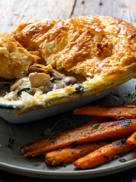 Chicken & Mushroom Pie served on a plate with carrots on the side