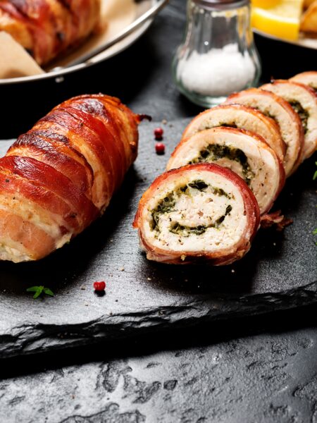 Chicken Stuffed with Cream Cheese served on a slate board