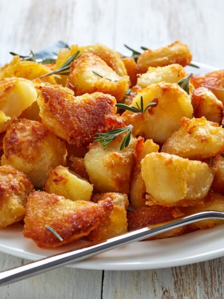 Killer Roast Potatoes served on a white plate