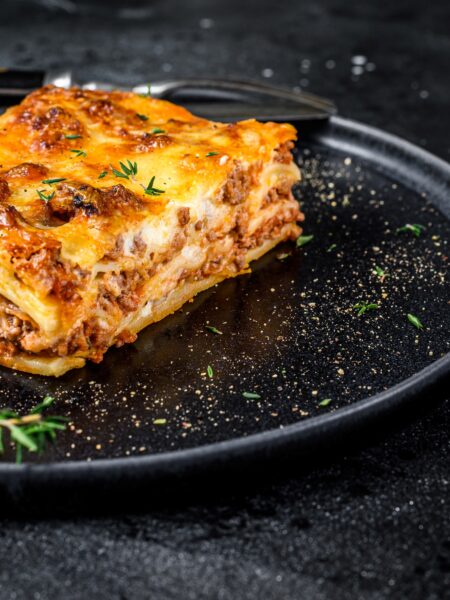 Four Cheese Lasagne served on a black plate